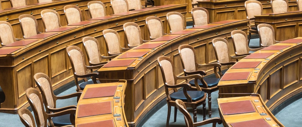 hansjorg-keller-p7av1ZhKGBQ-unsplash political assembly room chairs and desks