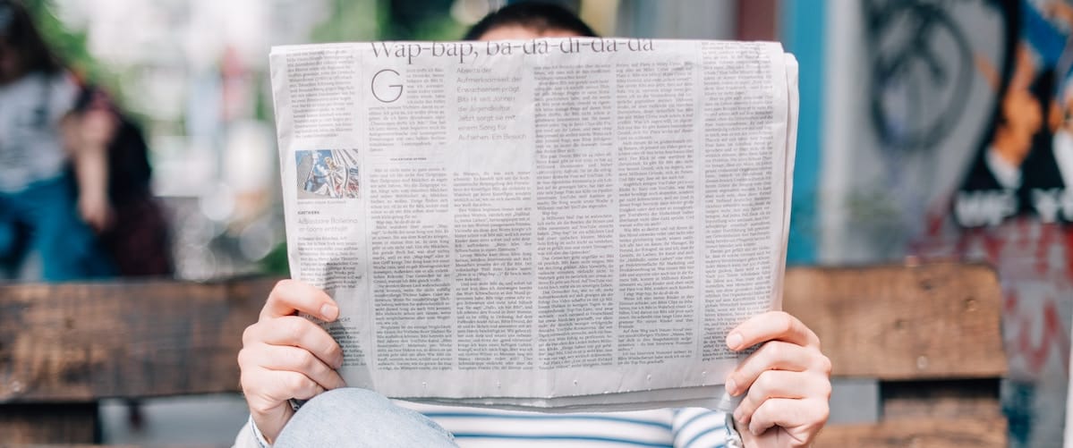roman-kraft-_Zua2hyvTBk-unsplash close up of man reading newspaper