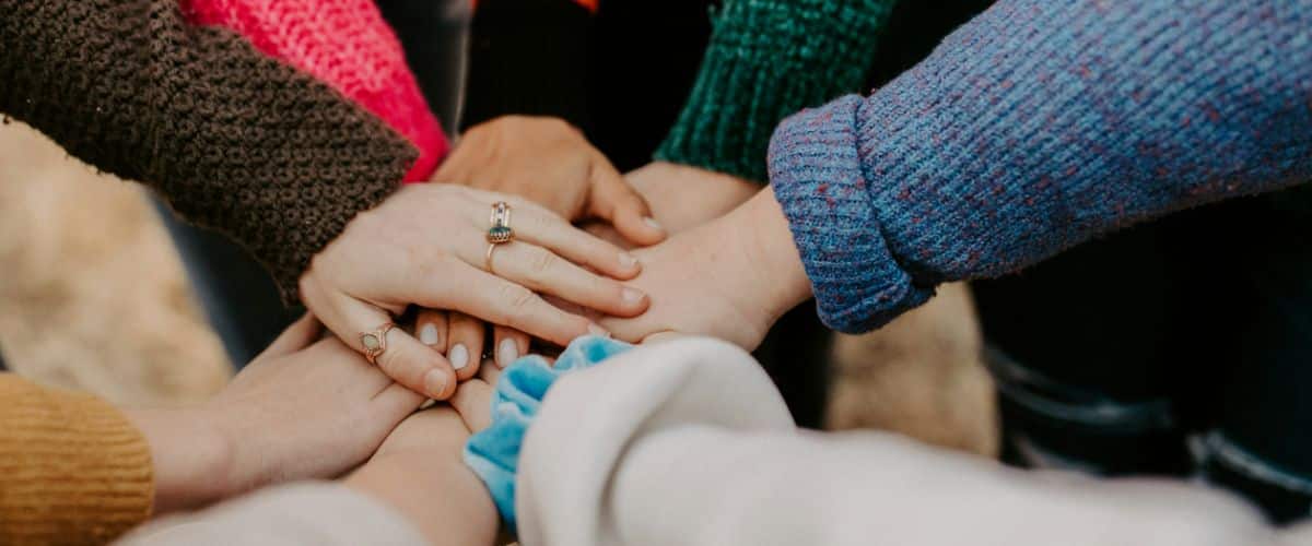Group of hands stacked together in a circle
